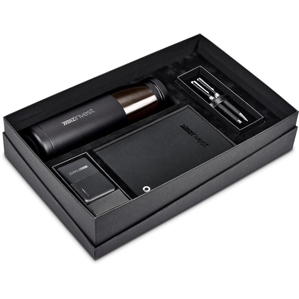 An open premium giftset mostly in black containing a bottle, pen-set, mobile power bank charger and notebook.