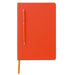 Orange notebook with an orange ballpoint pen