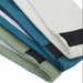 Close-up of resistance bands in green, blue, and white on a white background